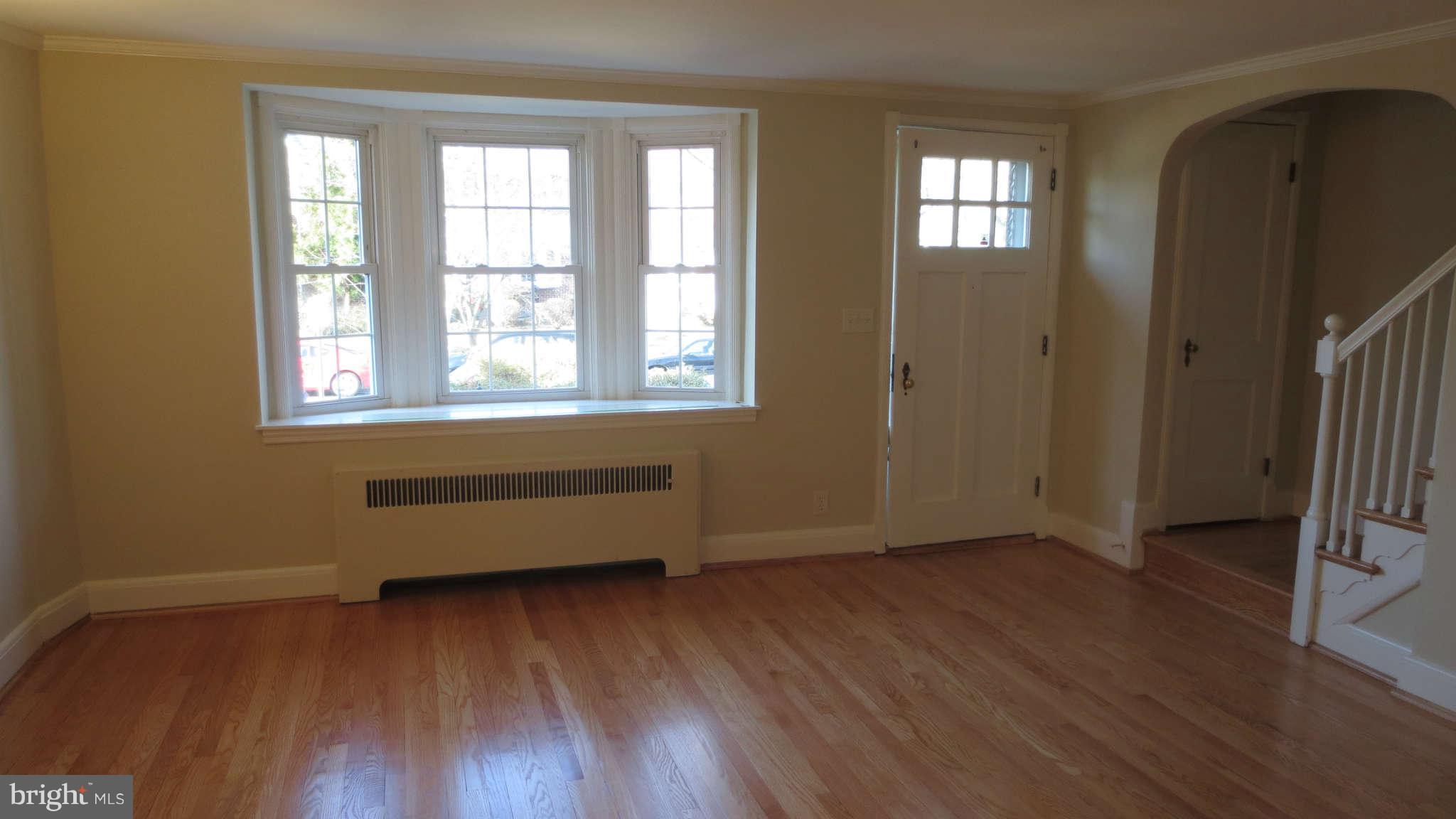 63 Murdock Road Baltimore, MD 21212 - Photo 4 of 16 an empty room with wooden floor and windows