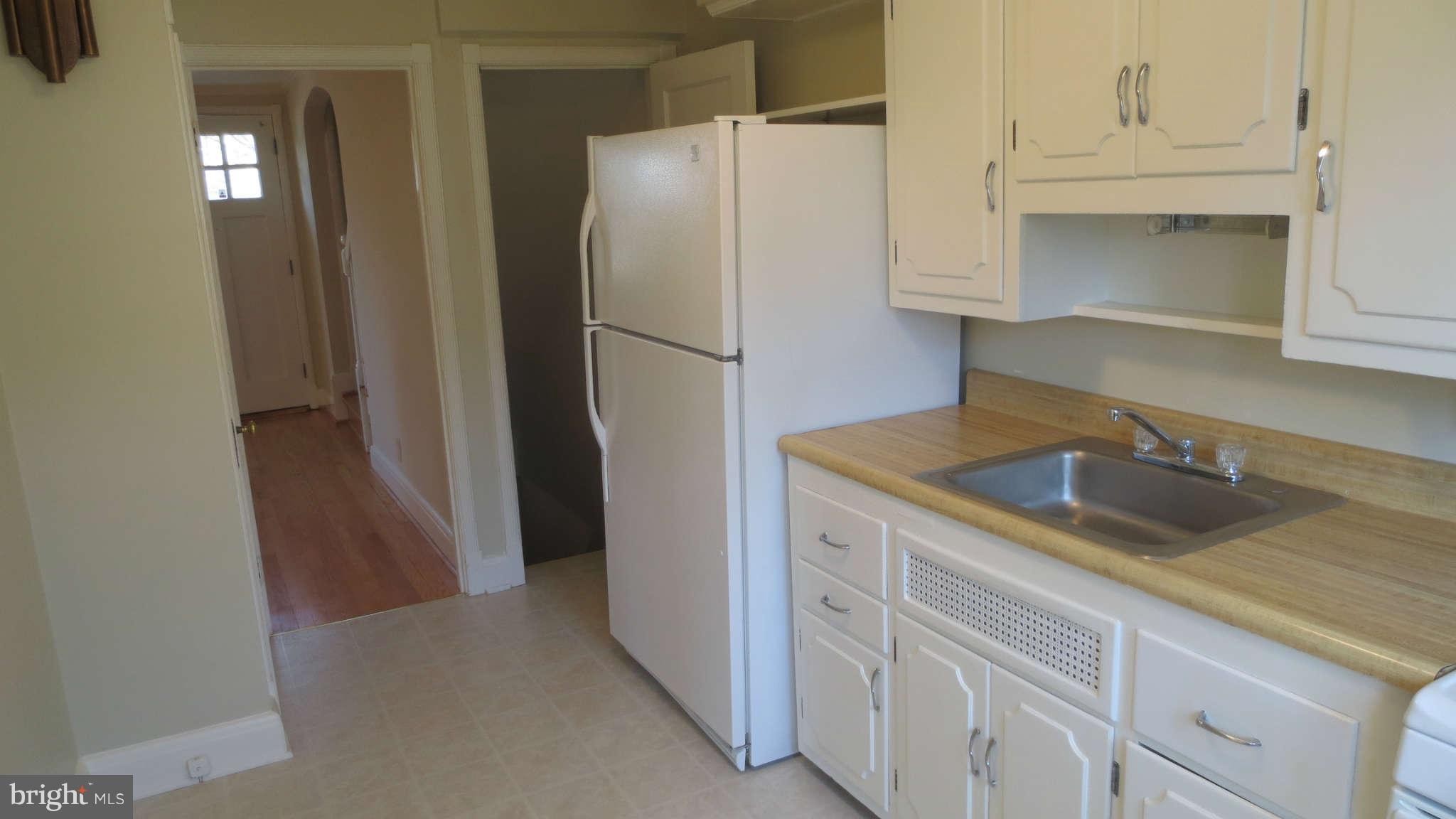 63 Murdock Road Baltimore, MD 21212 - Photo 6 of 16 a kitchen with a sink and refrigerator