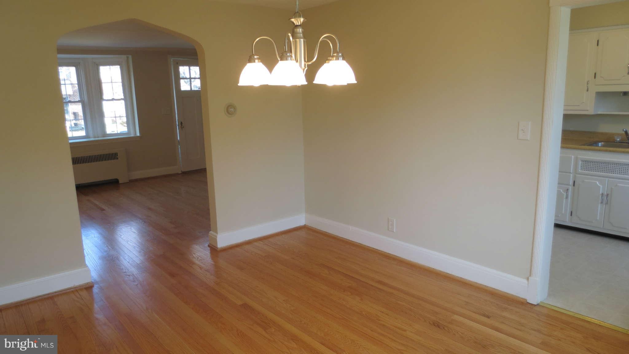63 Murdock Road Baltimore, MD 21212 - Photo 7 of 16 an empty room with wooden floor mirror and windows