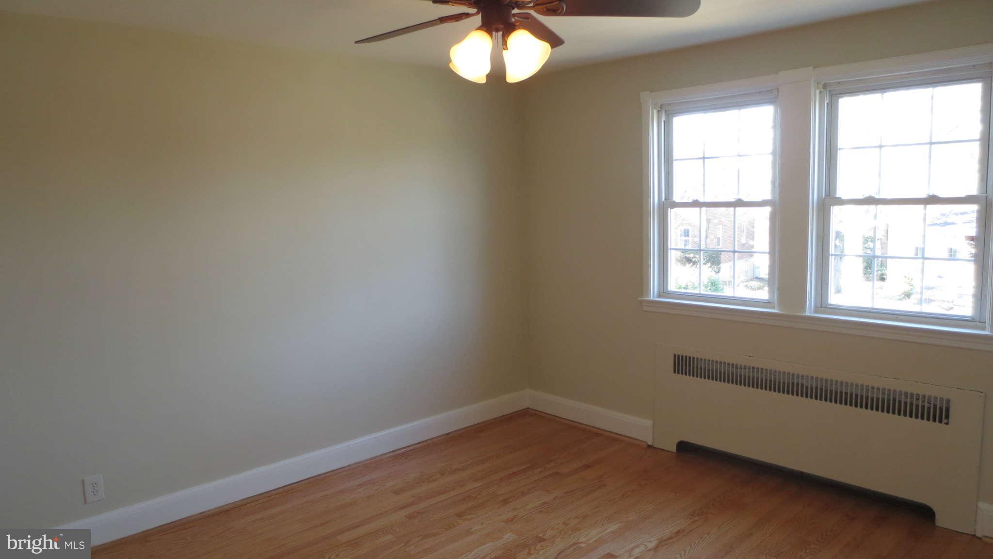 63 Murdock Road Baltimore, MD 21212 - Photo 10 of 16 wooden floor in an empty room with a window