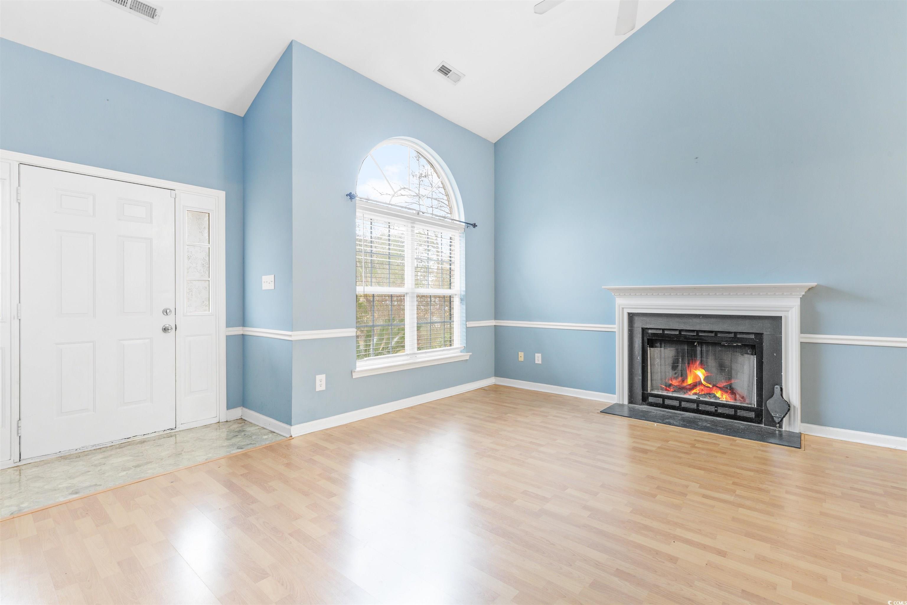 320 Muirfield Road Myrtle Beach, SC 29588 - Photo 23 of 40 Unfurnished living room featuring vaulted ceiling,