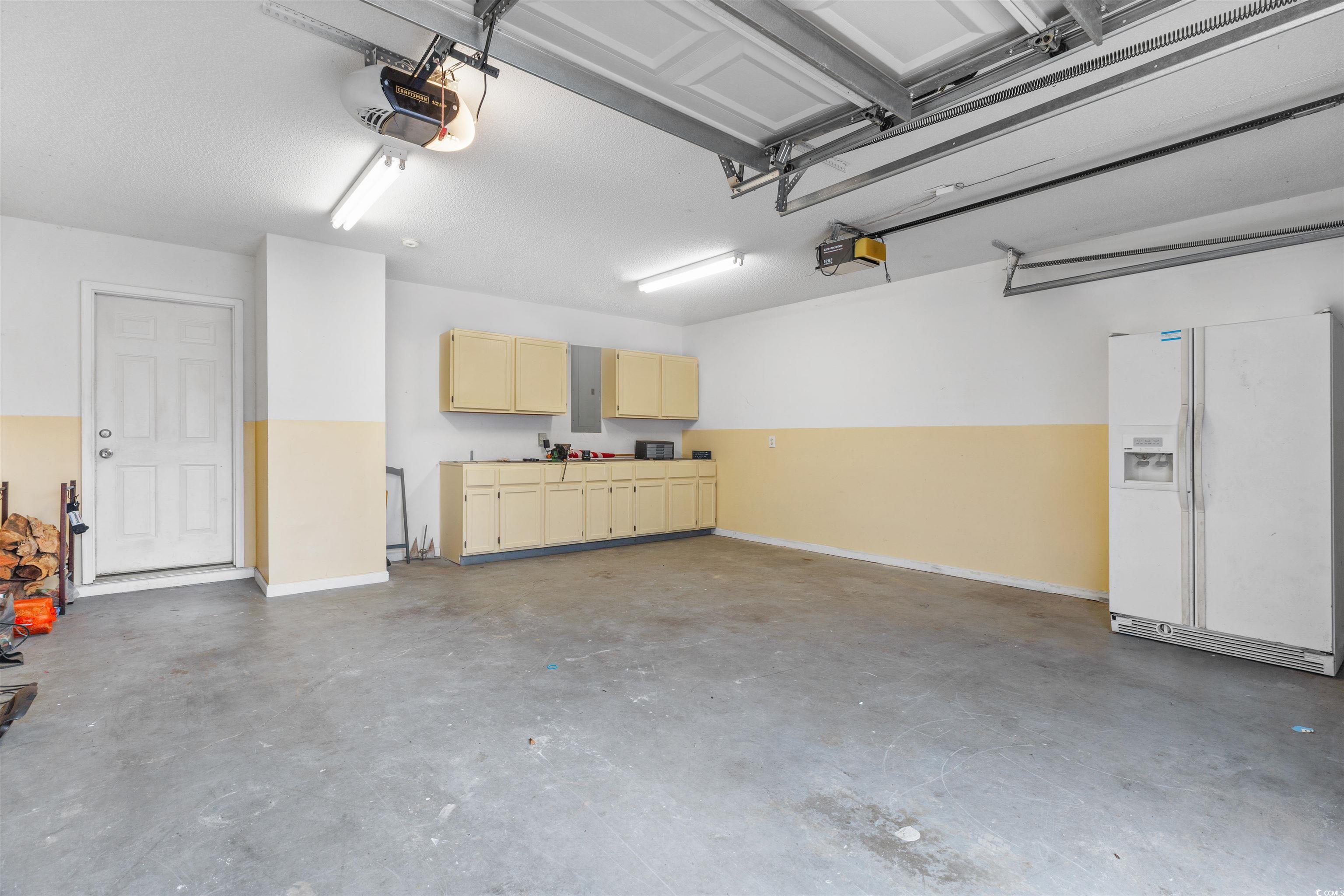 320 Muirfield Road Myrtle Beach, SC 29588 - Photo 38 of 40 Garage with two doors and built in work bench with