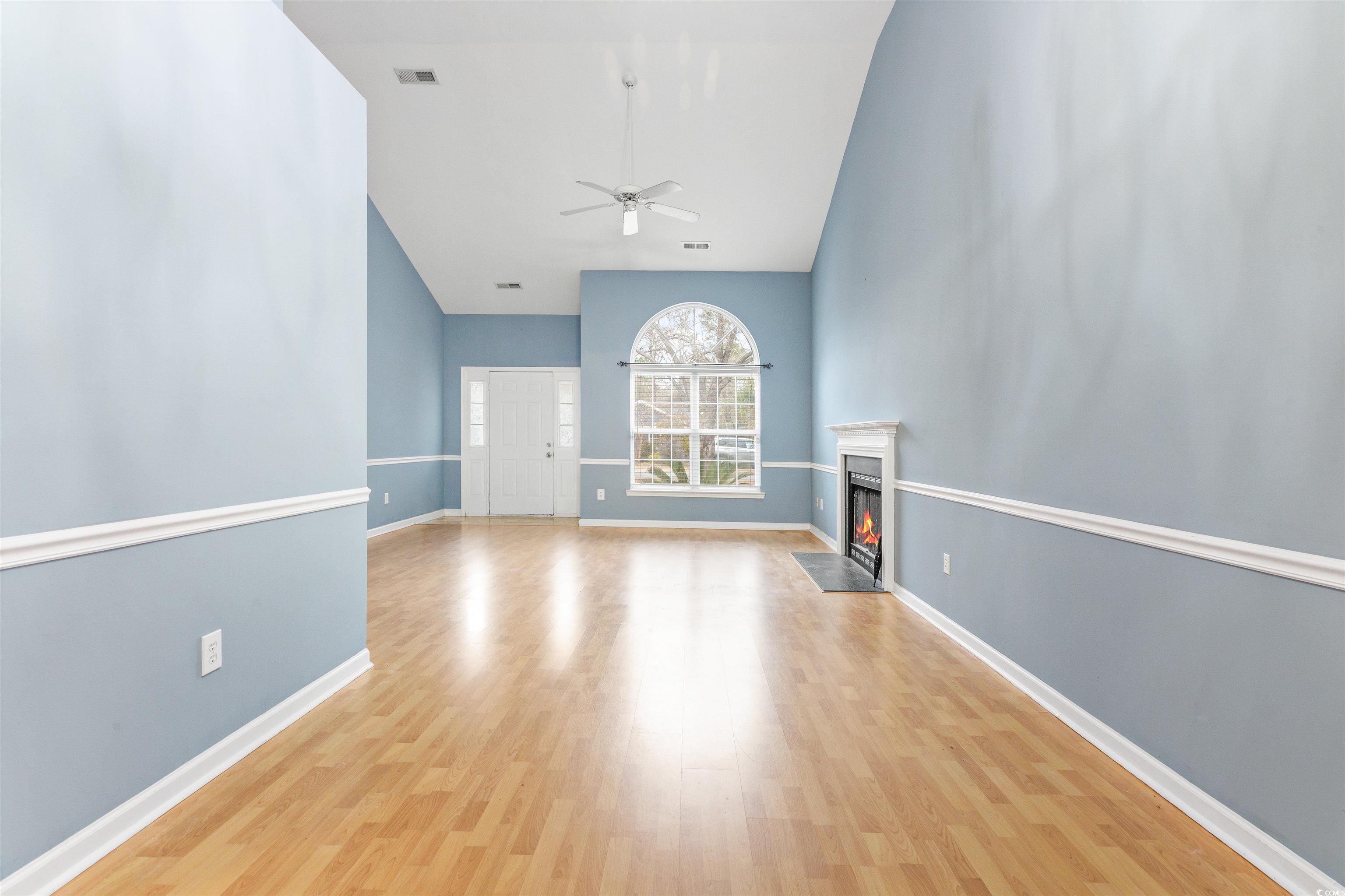 320 Muirfield Road Myrtle Beach, SC 29588 - Photo 9 of 40 Unfurnished living room with ceiling fan and light