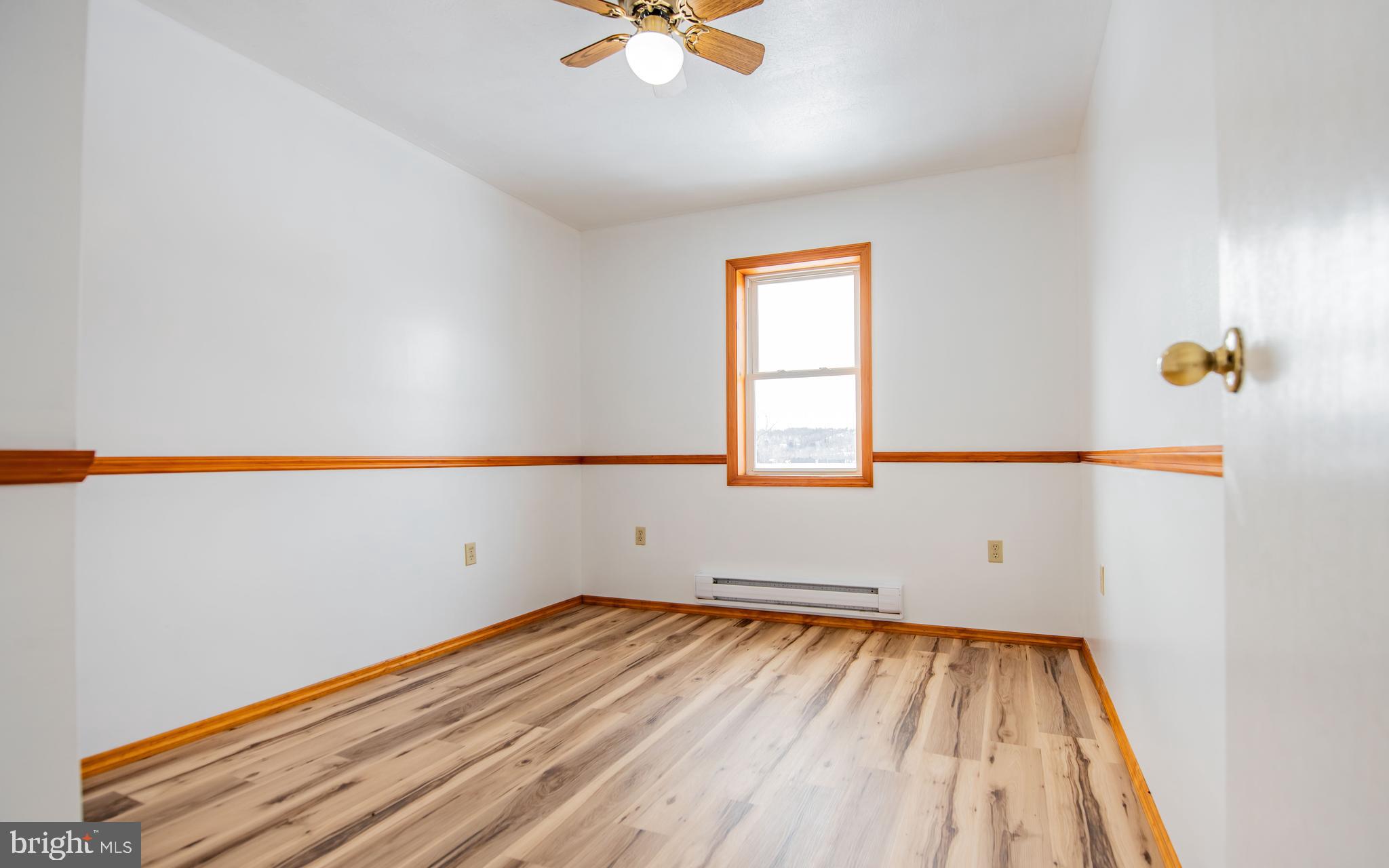 749 Farrandsville Road Lock Haven, PA 17745 - Photo 13 of 25 an empty room with a window and a ceiling fan