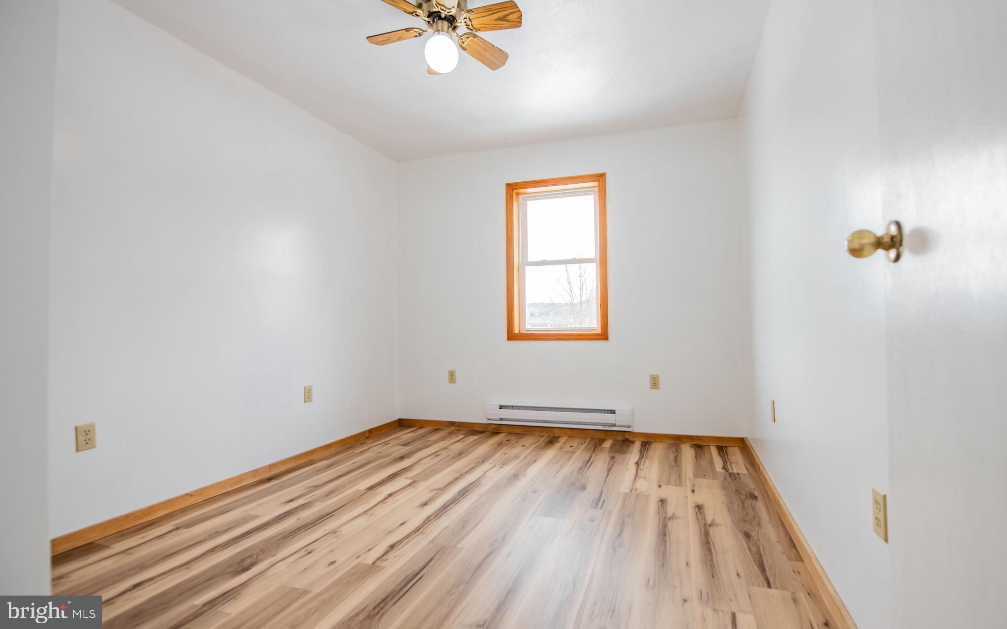 749 Farrandsville Road Lock Haven, PA 17745 - Photo 7 of 25 an empty room with a window and wooden floor