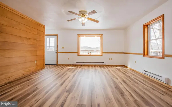 wooden floor in an empty room with a window