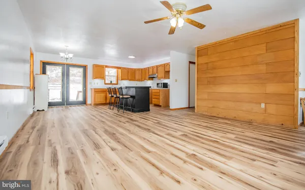 a view of empty room with a sink and wooden floor