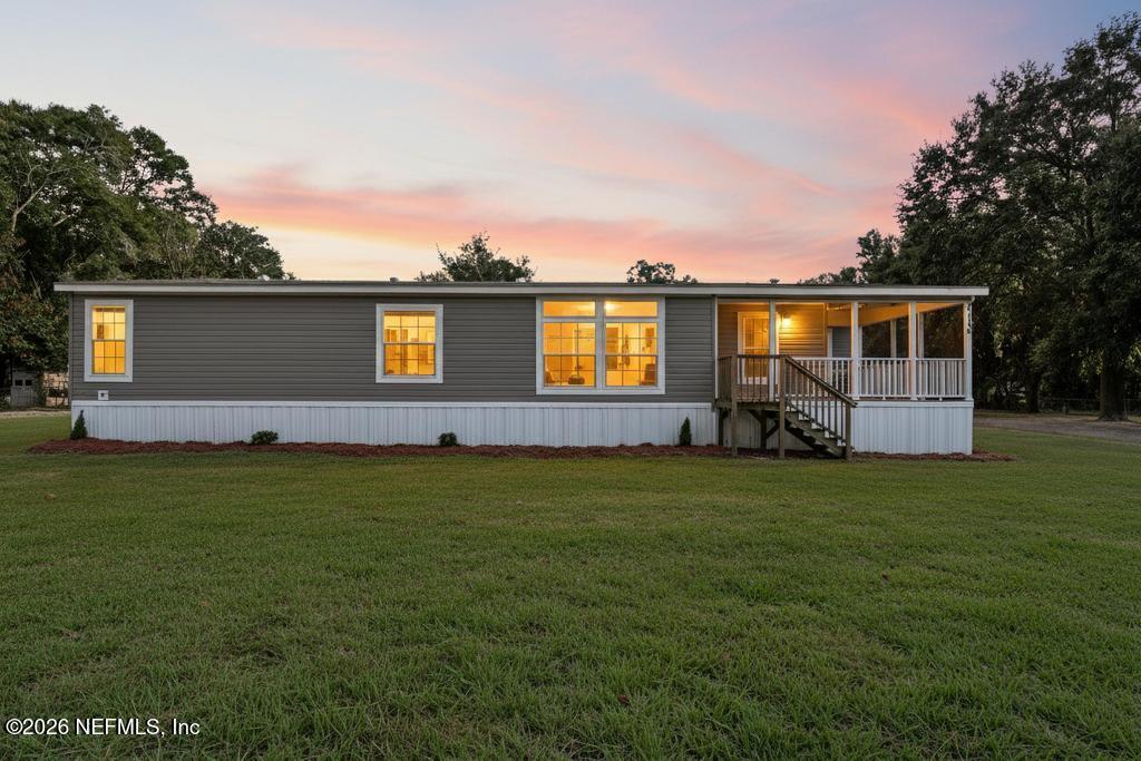 a front view of house with yard and outdoor seating