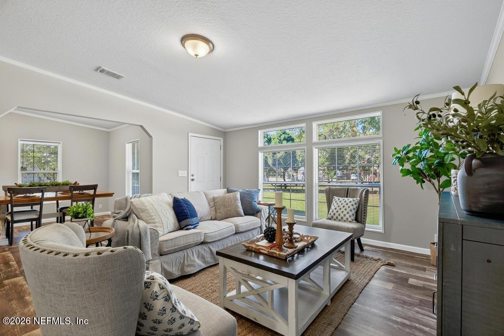 85146 Eady Lane Yulee, FL 32097 - Photo 18 of 74 a living room with furniture potted plant and a large window
