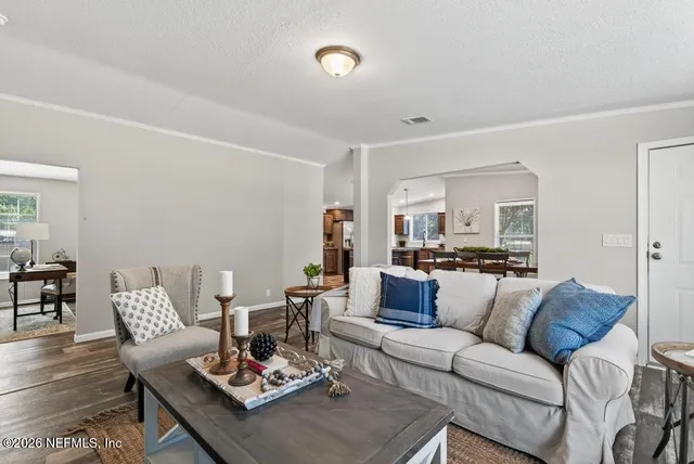 a kitchen with granite countertop a stove top oven microwave and cabinets