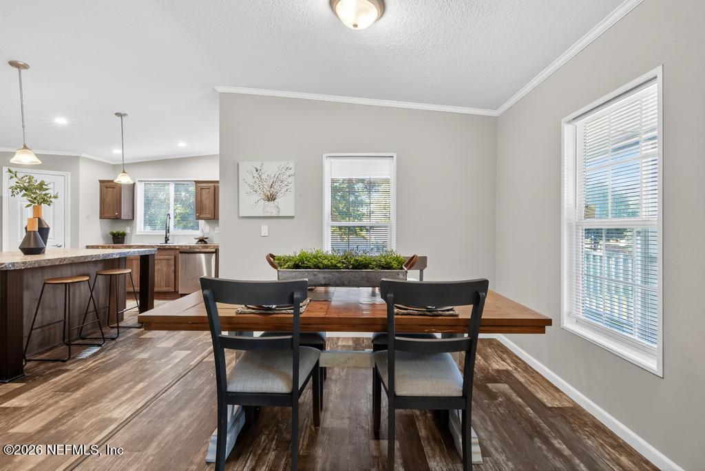 85146 Eady Lane Yulee, FL 32097 - Photo 20 of 74 a view of a dining room with furniture and wooden floor