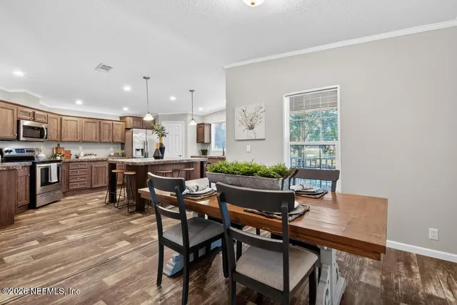 a kitchen with granite countertop a sink and a white wooden cabinets