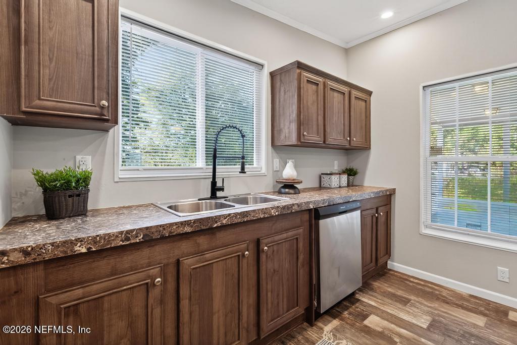 85146 Eady Lane Yulee, FL 32097 - Photo 28 of 74 a kitchen with granite countertop a sink a window and cabinets
