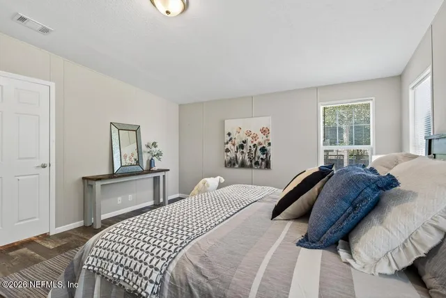 a view of grassy field with benches and trees all around