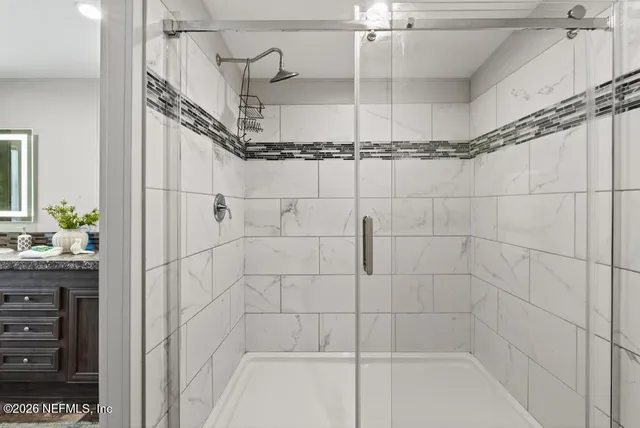 a backyard with a table and chairs and potted plants
