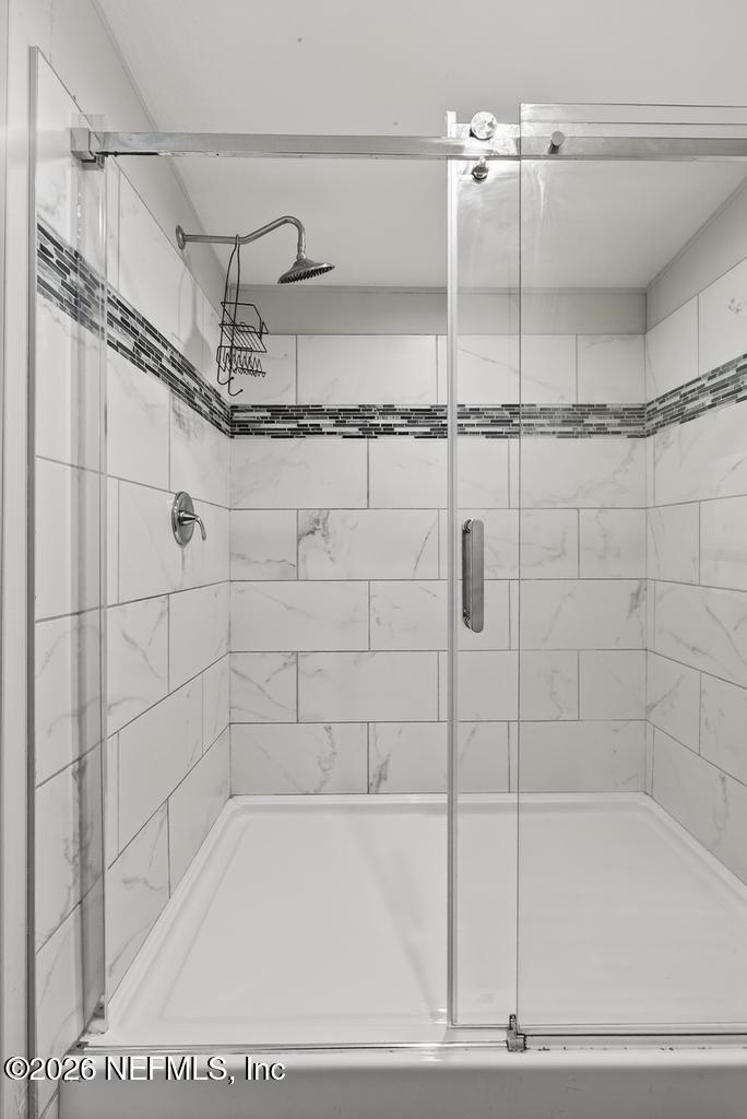 85146 Eady Lane Yulee, FL 32097 - Photo 50 of 74 a bathroom with a shower and a bathtub