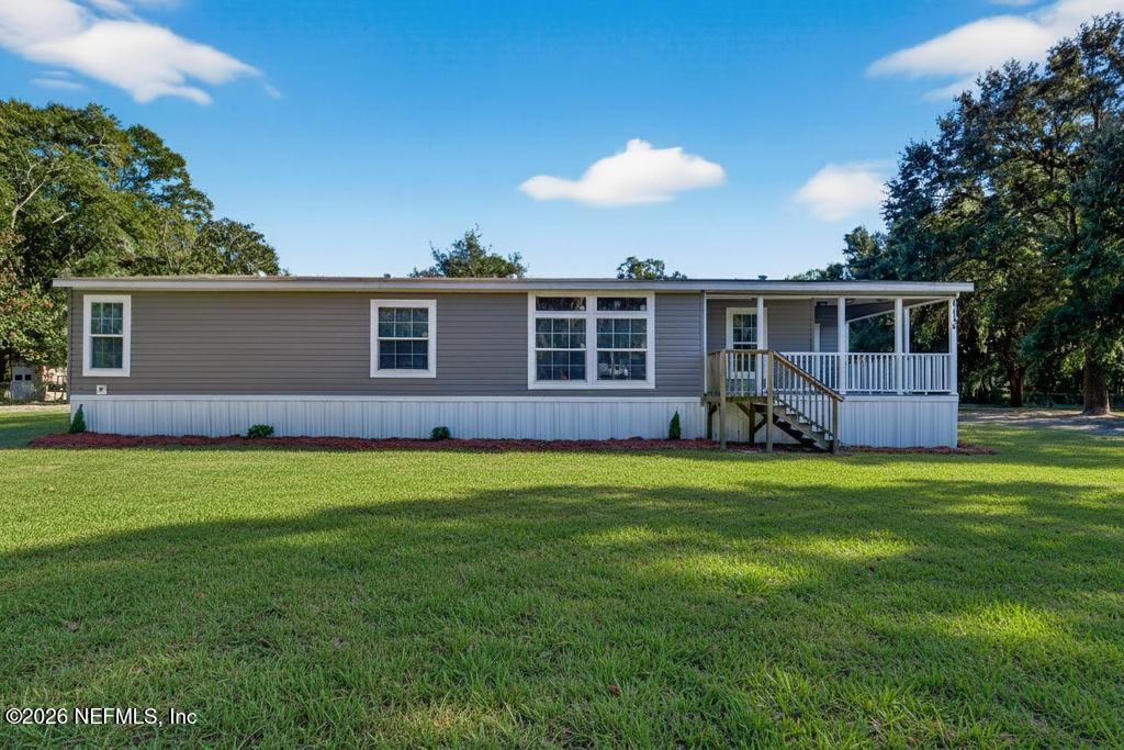 85146 Eady Lane Yulee, FL 32097 - Photo 8 of 74 a backyard of a house with wooden fence and floor to ceiling window