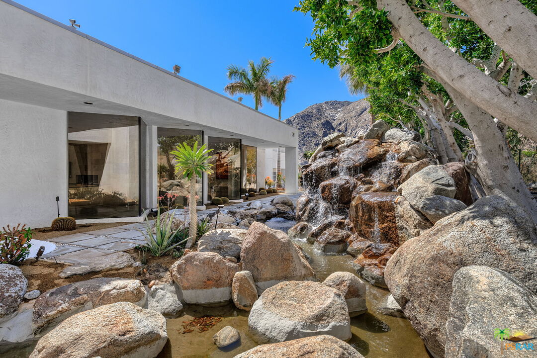 700 West Stevens Road Palm Springs, CA 92262 - Photo 16 of 54 a view of a chairs and table in a backyard