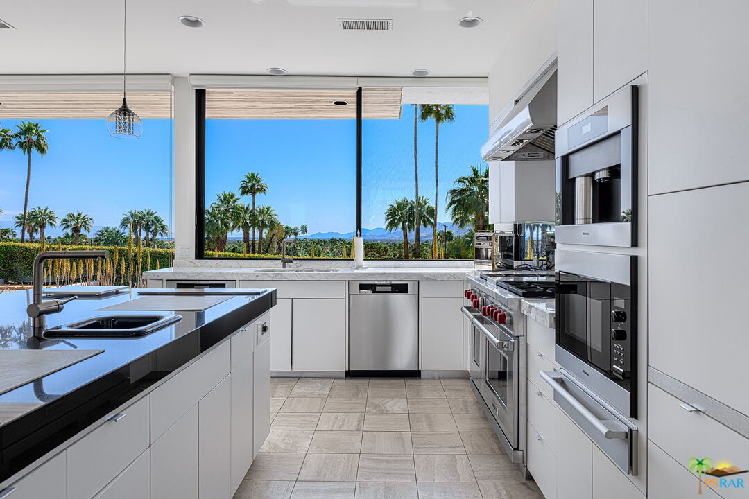700 West Stevens Road Palm Springs, CA 92262 - Photo 20 of 54 a kitchen with stainless steel appliances granite countertop a sink and cabinets