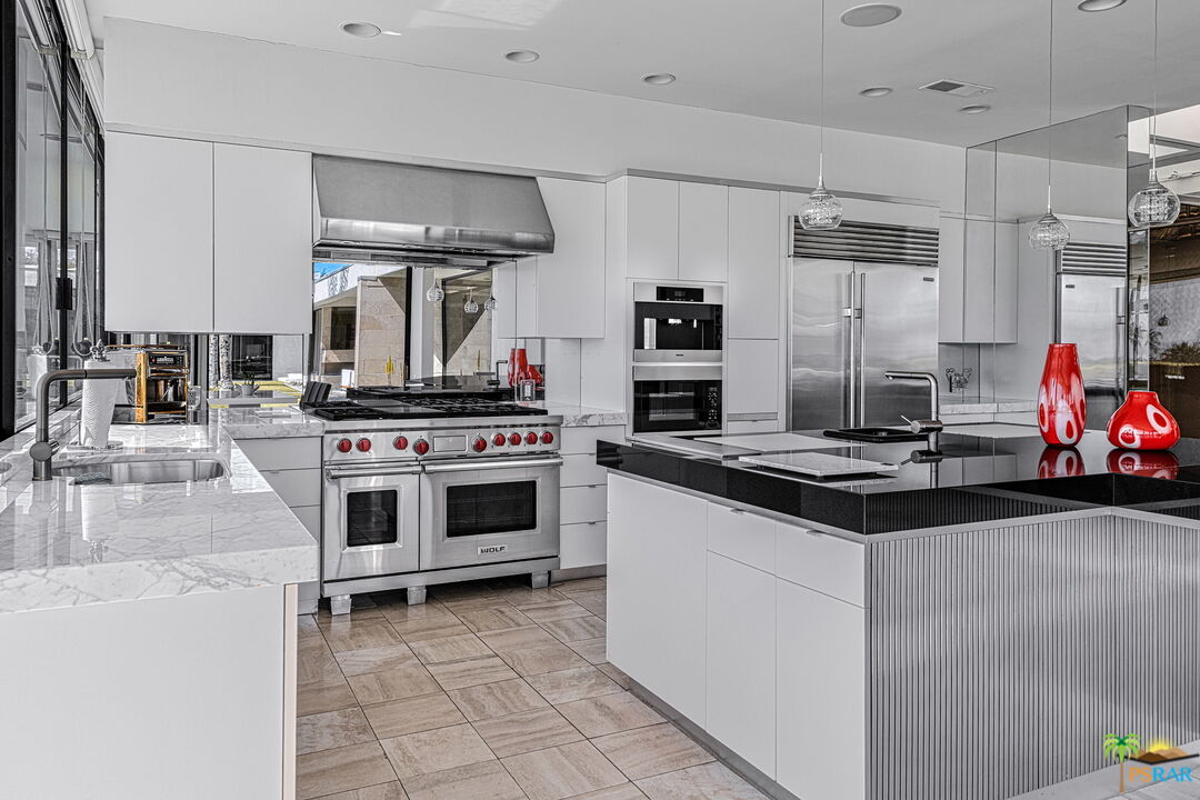 700 West Stevens Road Palm Springs, CA 92262 - Photo 21 of 54 a kitchen with a stove and a sink