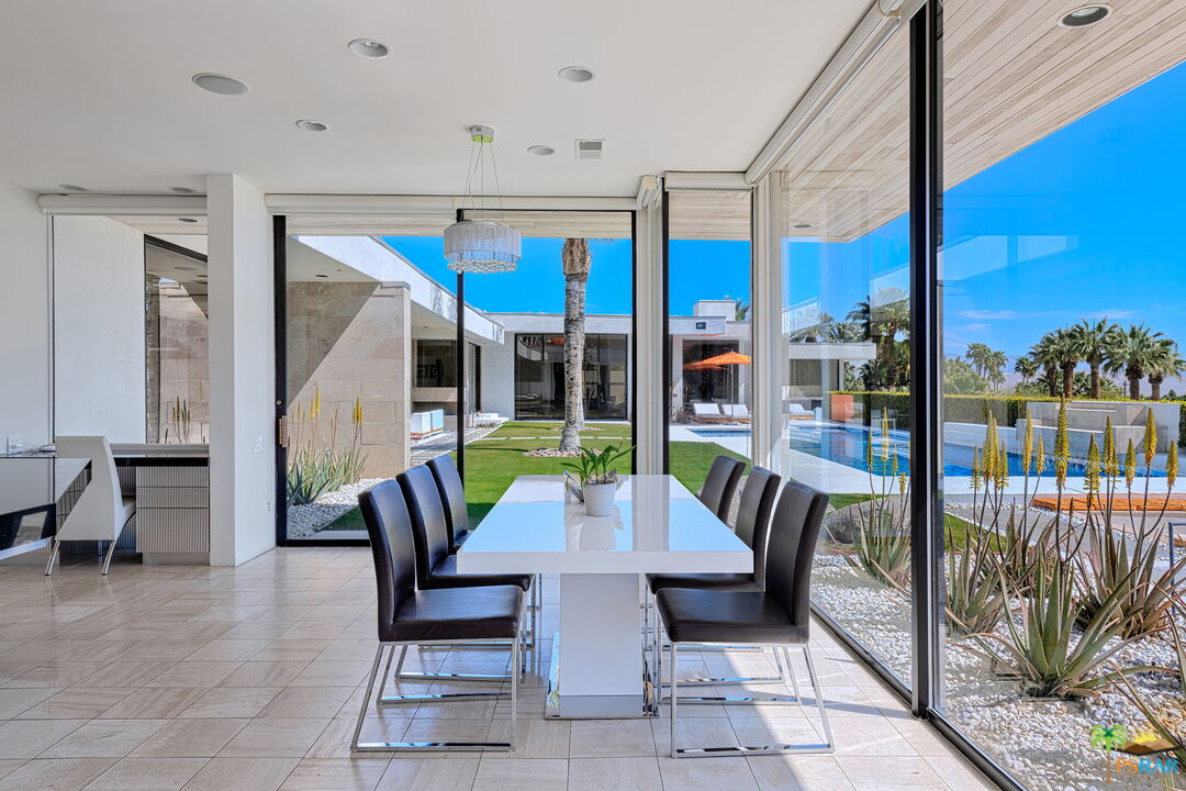 700 West Stevens Road Palm Springs, CA 92262 - Photo 23 of 54 a view of a patio with a table and chairs