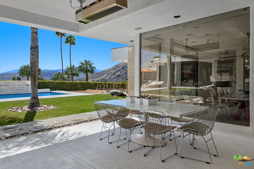 700 West Stevens Road Palm Springs, CA 92262 - Photo 25 of 54 a view of a patio with a table chairs and a small yard
