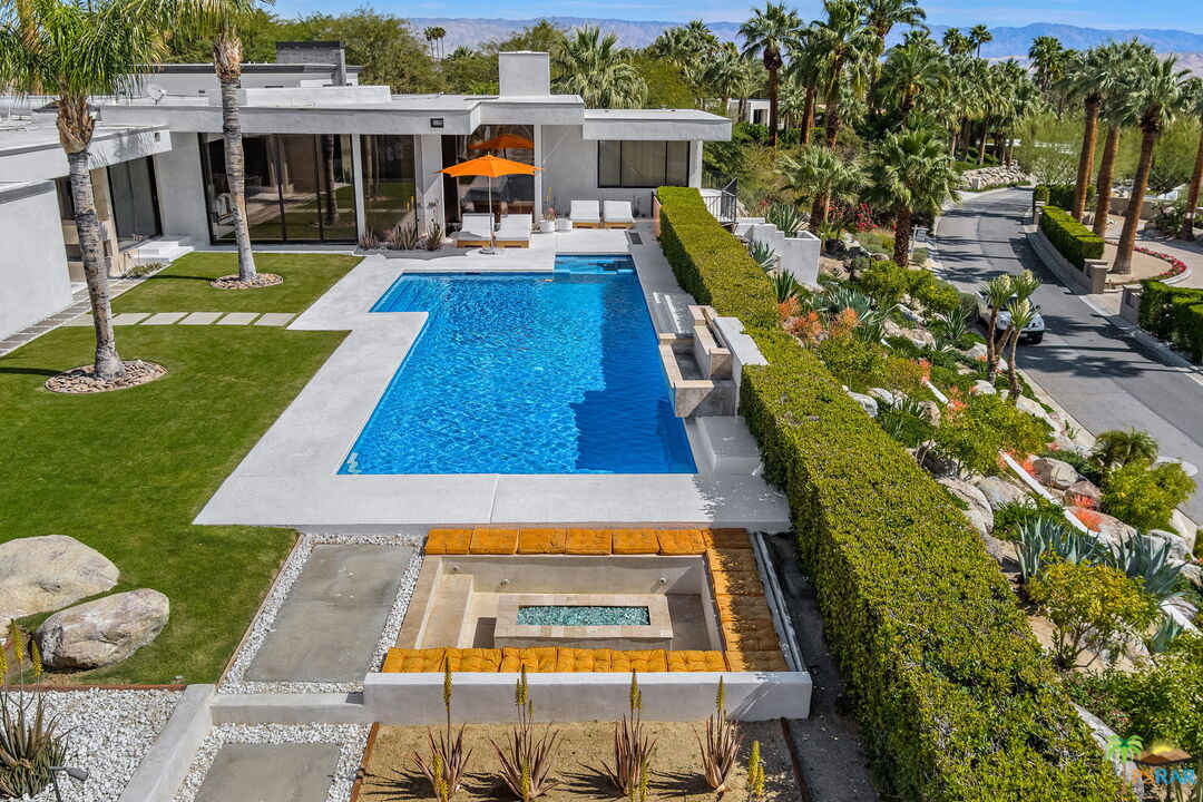 700 West Stevens Road Palm Springs, CA 92262 - Photo 29 of 54 a view of a house with swimming pool lawn chairs and a yard