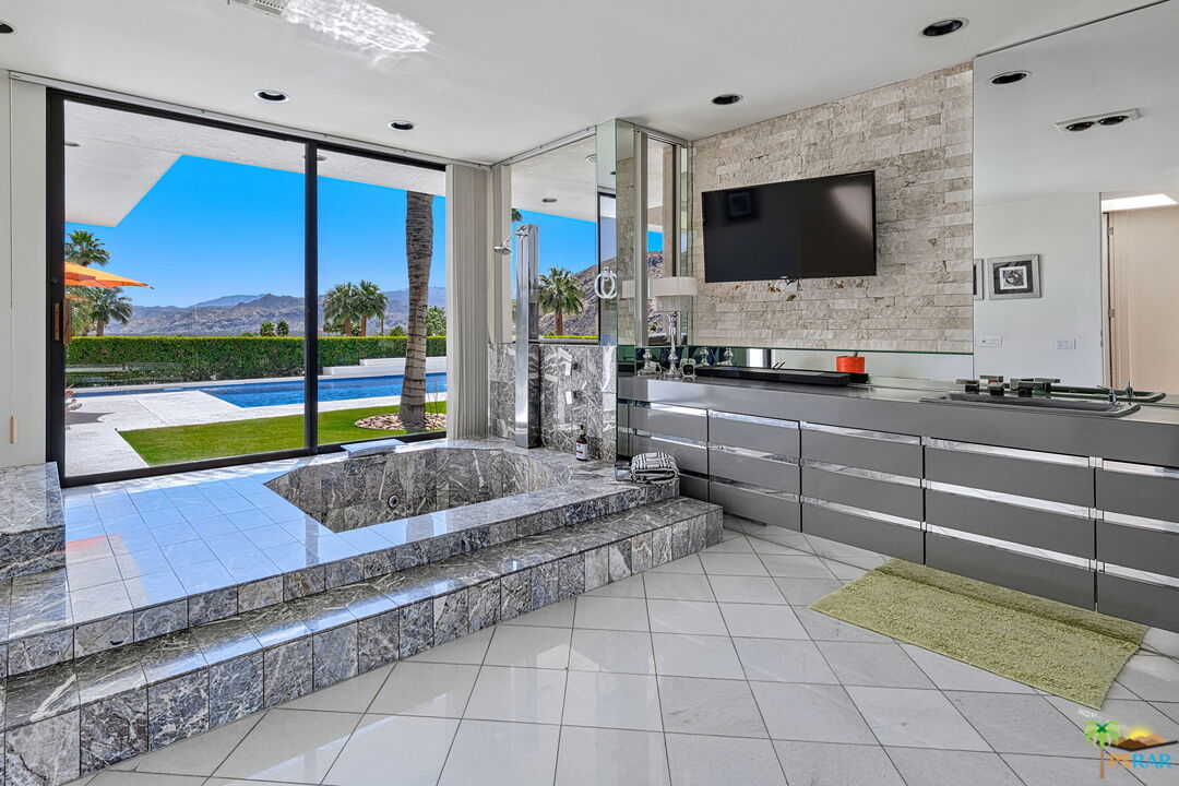 700 West Stevens Road Palm Springs, CA 92262 - Photo 36 of 54 a kitchen with stainless steel appliances kitchen island granite countertop a sink and a counter top space