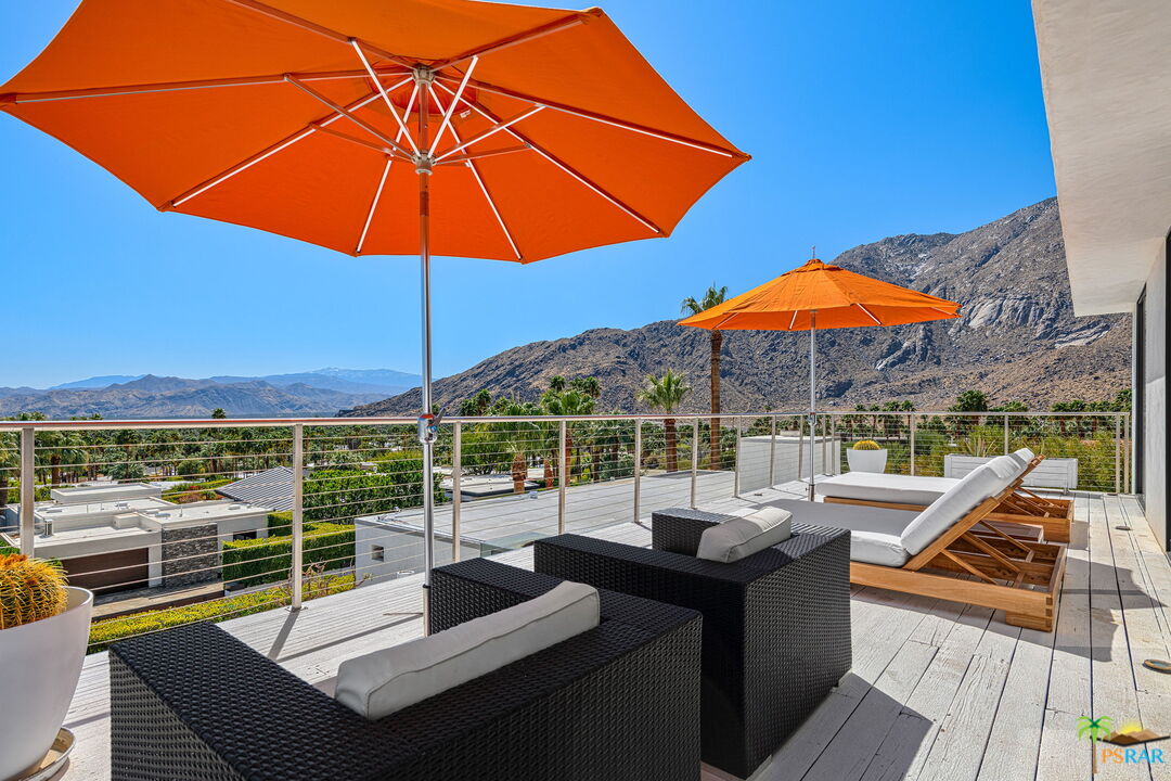 700 West Stevens Road Palm Springs, CA 92262 - Photo 43 of 54 a view of a patio with couches under an umbrella