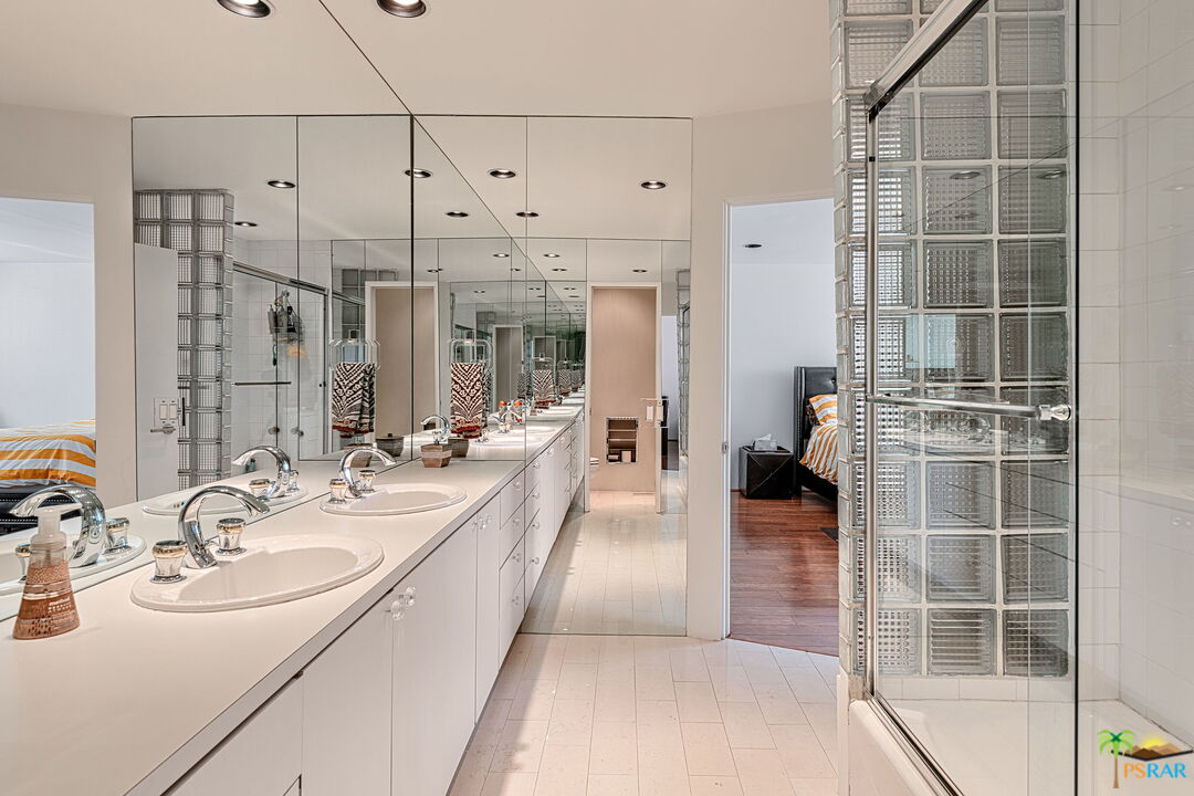 700 West Stevens Road Palm Springs, CA 92262 - Photo 46 of 54 a en suite bathroom with a double vanity sink a mirror and shower