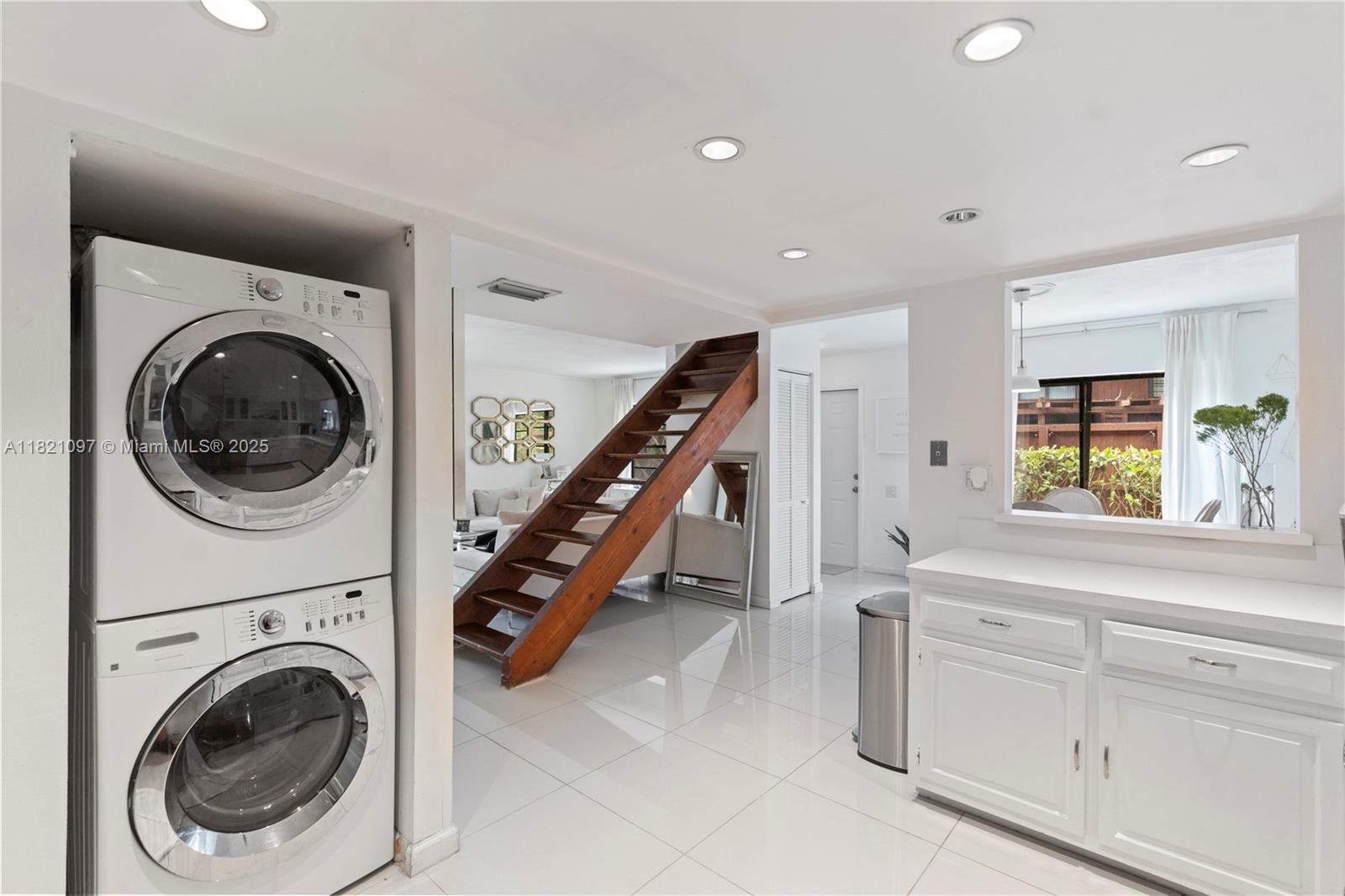 7074 Southwest 114th Place, Unit H Miami, FL 33173 - Photo 14 of 38 a view of a hallway with washer and dryer