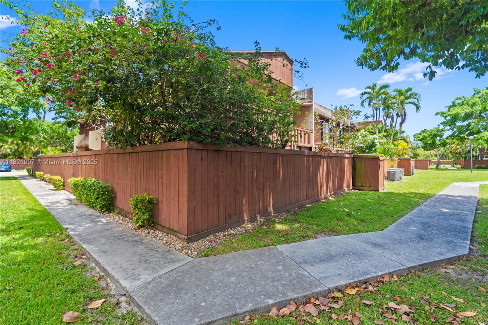 7074 Southwest 114th Place, Unit H Miami, FL 33173 - Photo 34 of 38 a view of a backyard with a plants and trees