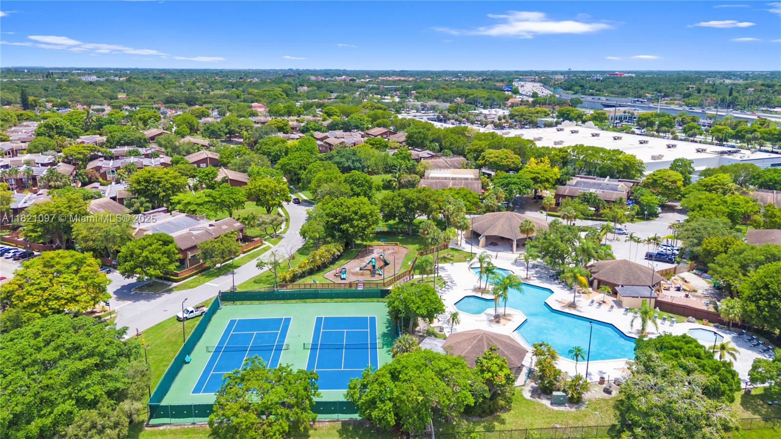 7074 Southwest 114th Place, Unit H Miami, FL 33173 - Photo 36 of 38 an aerial view of residential houses with outdoor space and trees