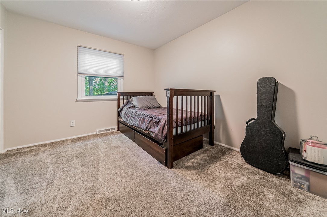 595 Moorfield Road Fairlawn, OH 44313 - Photo 23 of 50 Carpeted bedroom with baseboards and lofted ceiling