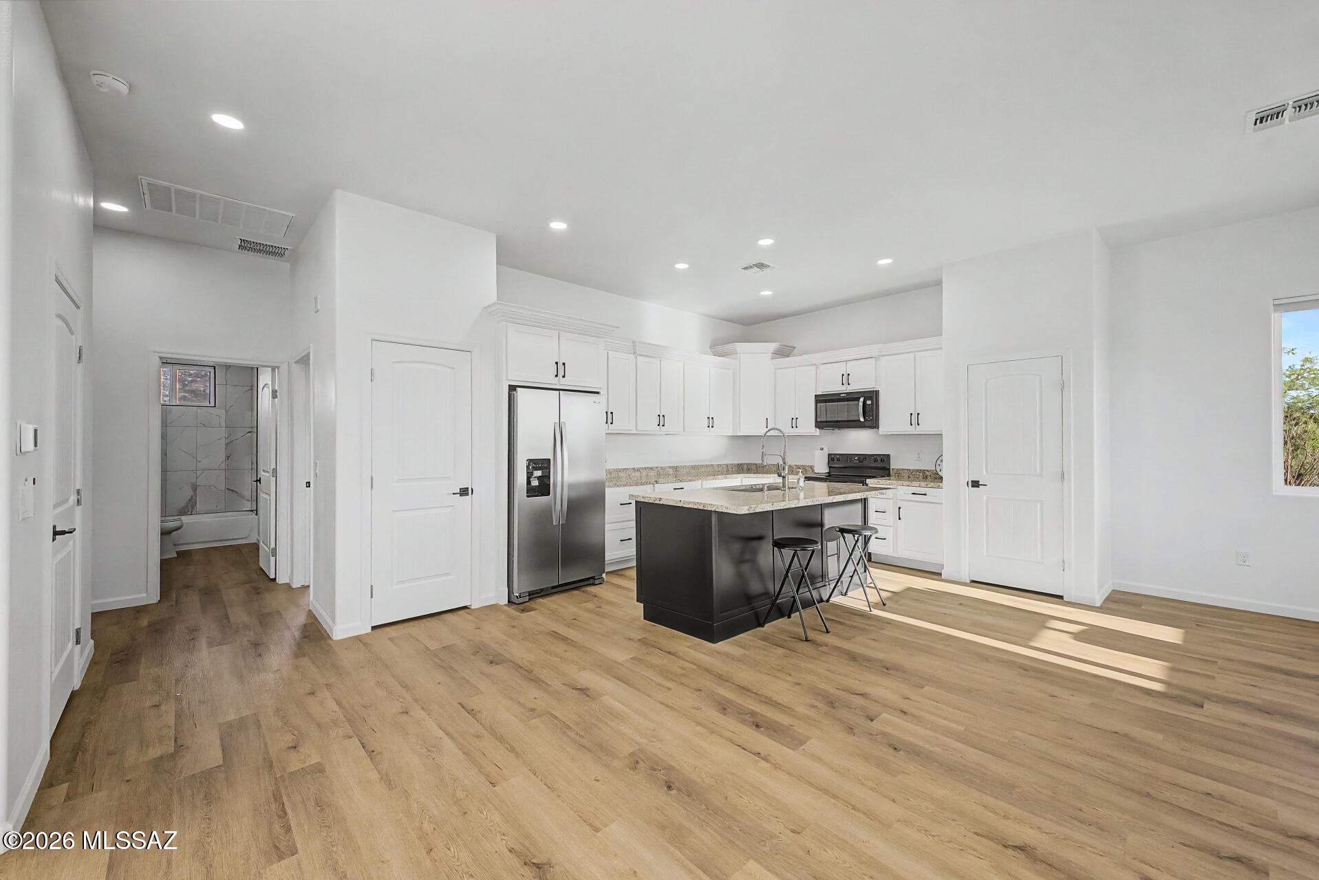 4601 East Magoo Road Tucson, AZ 85739 - Photo 6 of 38 a large kitchen with a refrigerator and a stove top oven