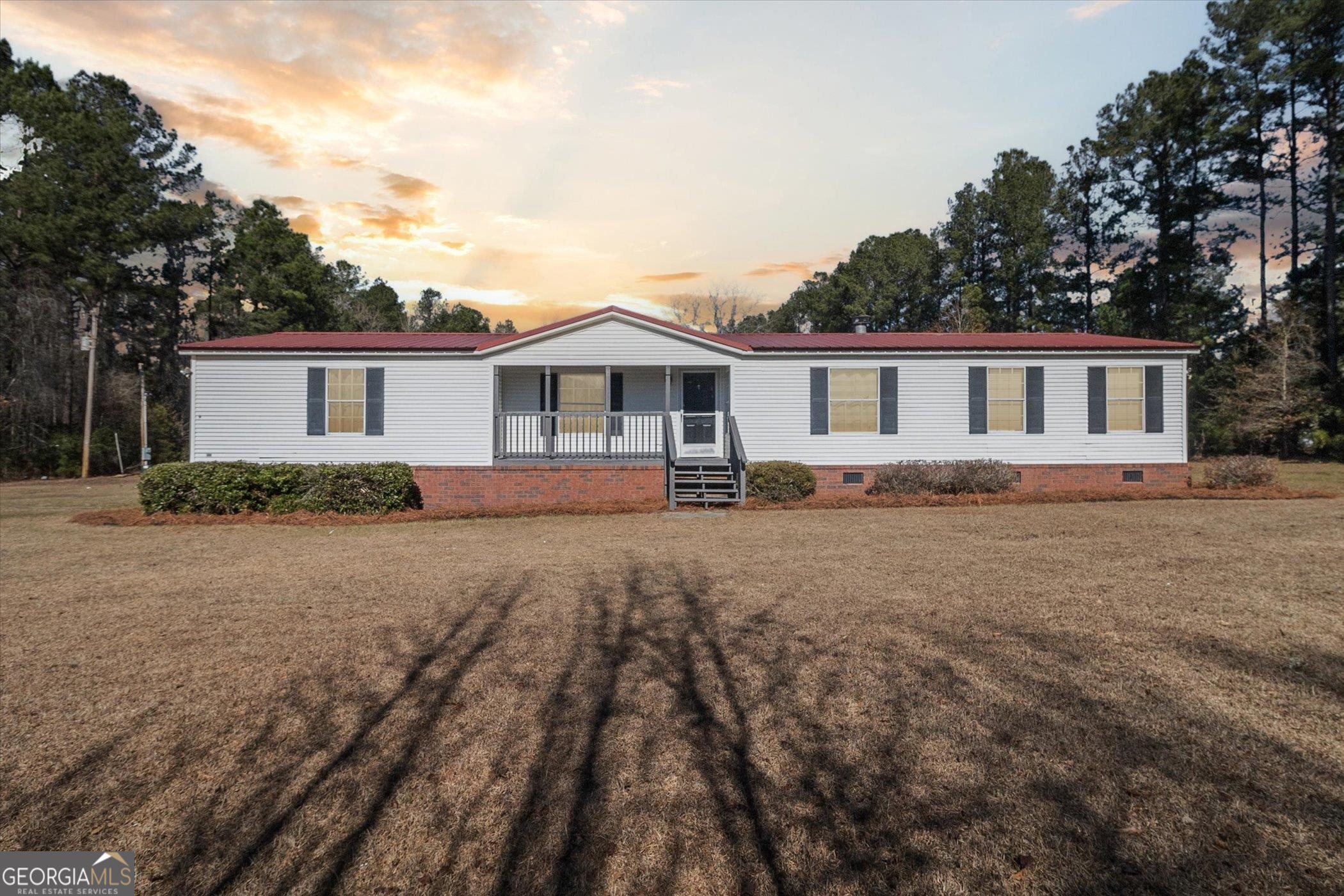 5717 Pearl Road Ellabell, GA 31308 - Photo 1 of 1 a front view of house with yard and trees around