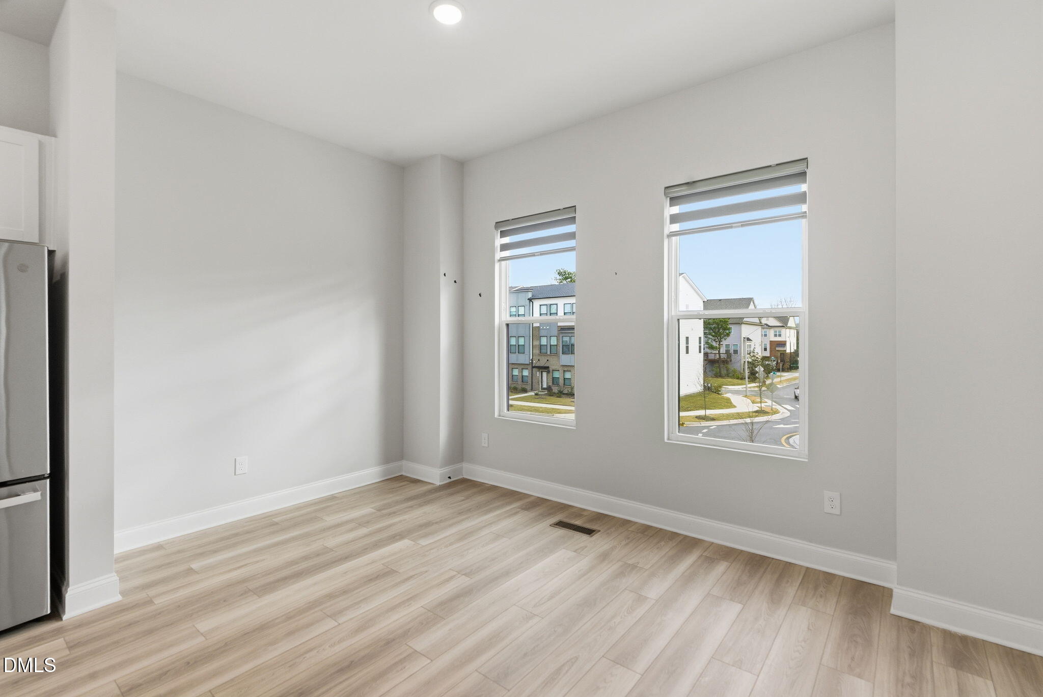 501 Hedrick Ridge Road Cary, NC 27519 - Photo 15 of 47 a view of an empty room with wooden floor and a window