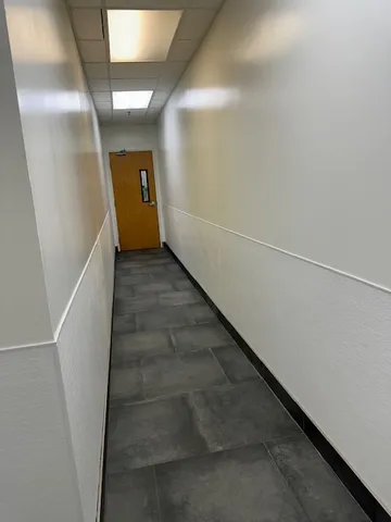 a room with a white furniture and wooden floor