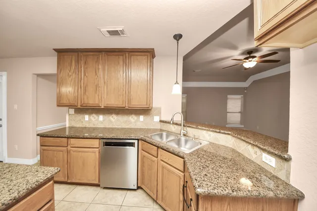 a kitchen with a sink stove and cabinets