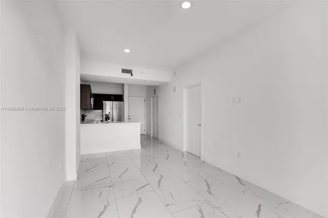 a view of open kitchen with a sink and cabinets