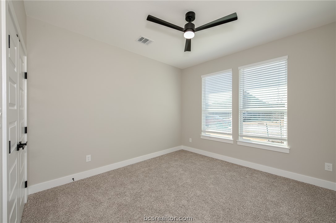 2908 GOLDBERG Drive Bryan, TX 77808 - Photo 8 of 44 Bedroom features: window treatments, base molding, ceiling fan with a light kit plus remote control and carpeting.