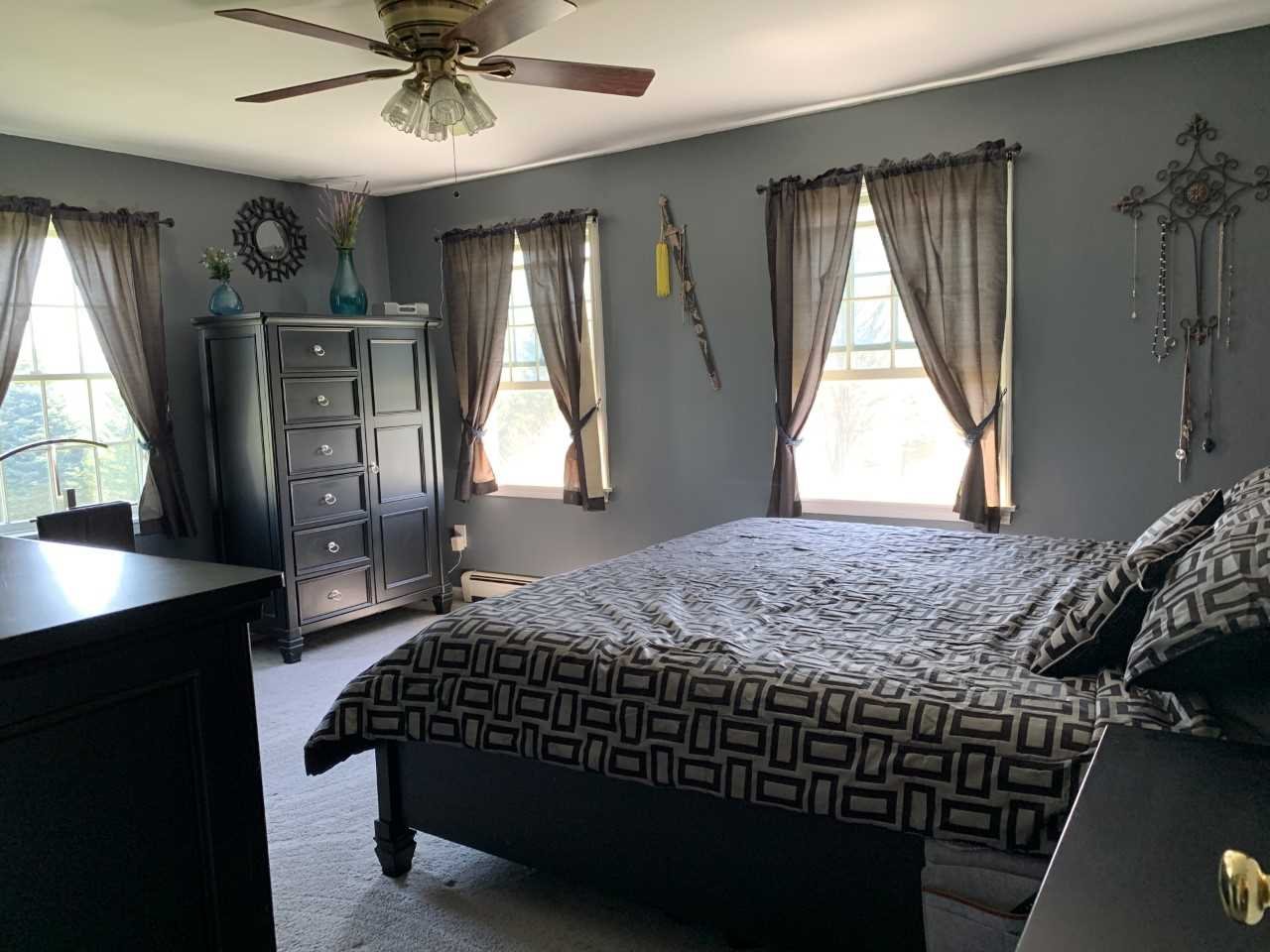 32 Spencer Lane Millerton, NY 12546 - Photo 23 of 29 a bedroom with a bed and a chandelier