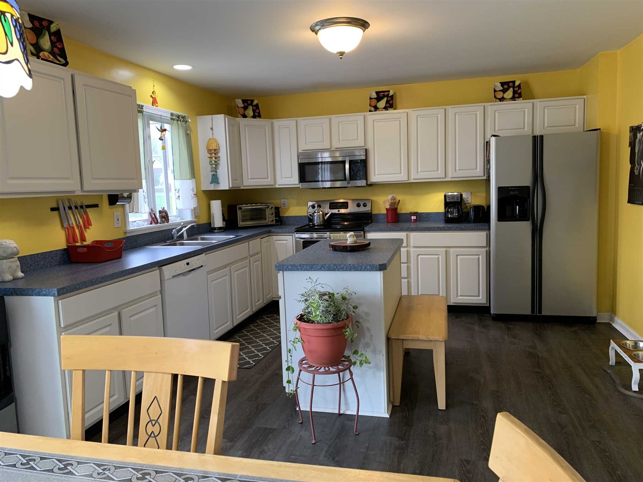 32 Spencer Lane Millerton, NY 12546 - Photo 10 of 29 a kitchen with stainless steel appliances granite countertop a refrigerator a stove a sink dishwasher a stove and white cabinets with wooden floor