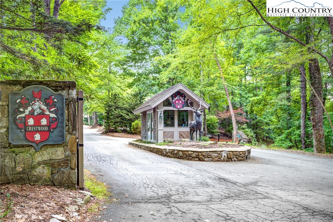 145 Inn At Crestwood Drive Boone, NC 28607 - Photo 17 of 18 a front view of a house with a yard and garage