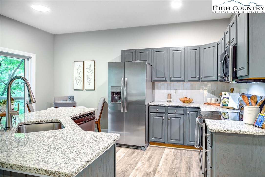 145 Inn At Crestwood Drive Boone, NC 28607 - Photo 5 of 18 a kitchen with stainless steel appliances granite countertop a refrigerator stove top oven and sink
