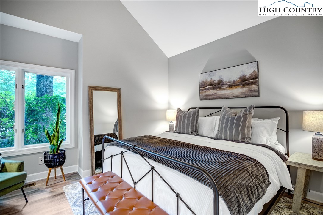 145 Inn At Crestwood Drive Boone, NC 28607 - Photo 8 of 18 a bedroom with a bed and a painting on the wall