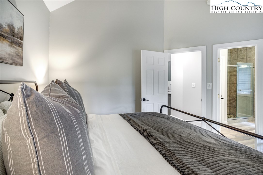 145 Inn At Crestwood Drive Boone, NC 28607 - Photo 9 of 18 a bedroom with a bed and a mirror