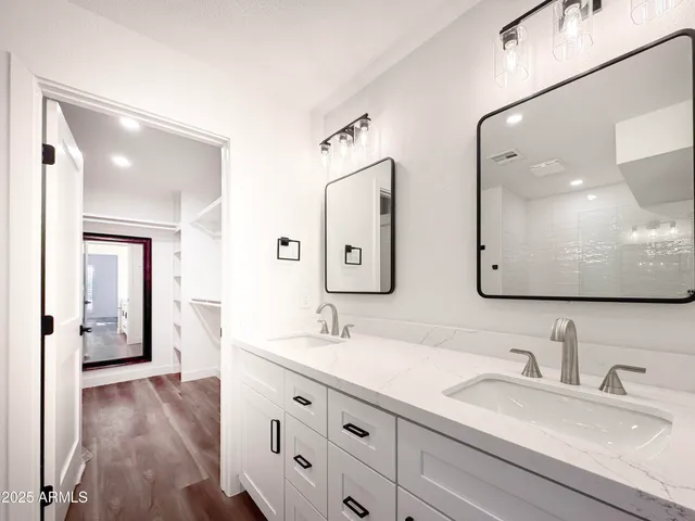 a bathroom with a granite countertop sink toilet a large mirror a vanity and shower