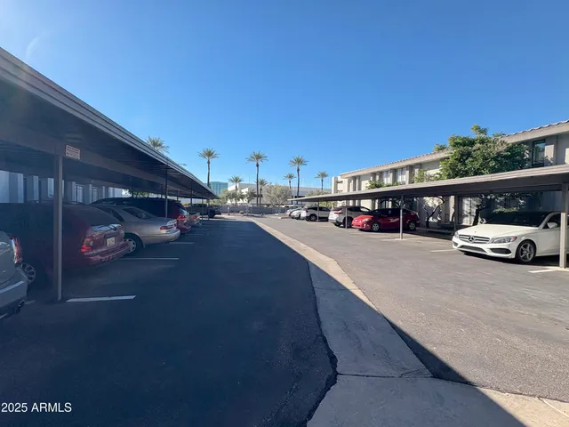 a view of a patio with table and chairs with wooden fence