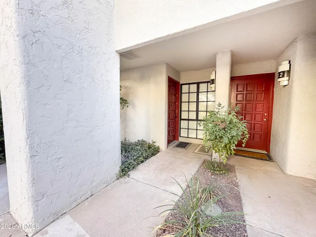 a view of a patio with table and chairs and potted plants